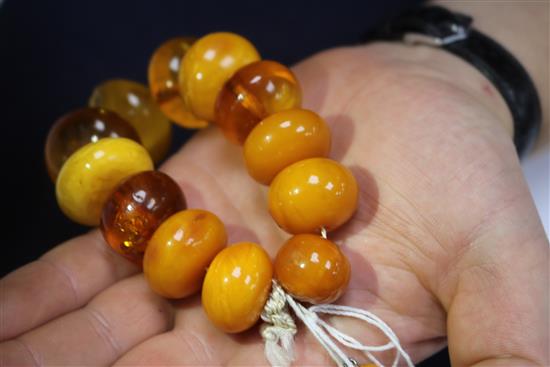 A single strand graduated oval amber bead necklace with spacers and an amber bead bracelet, gross weight 130 grams, necklace 46cm.